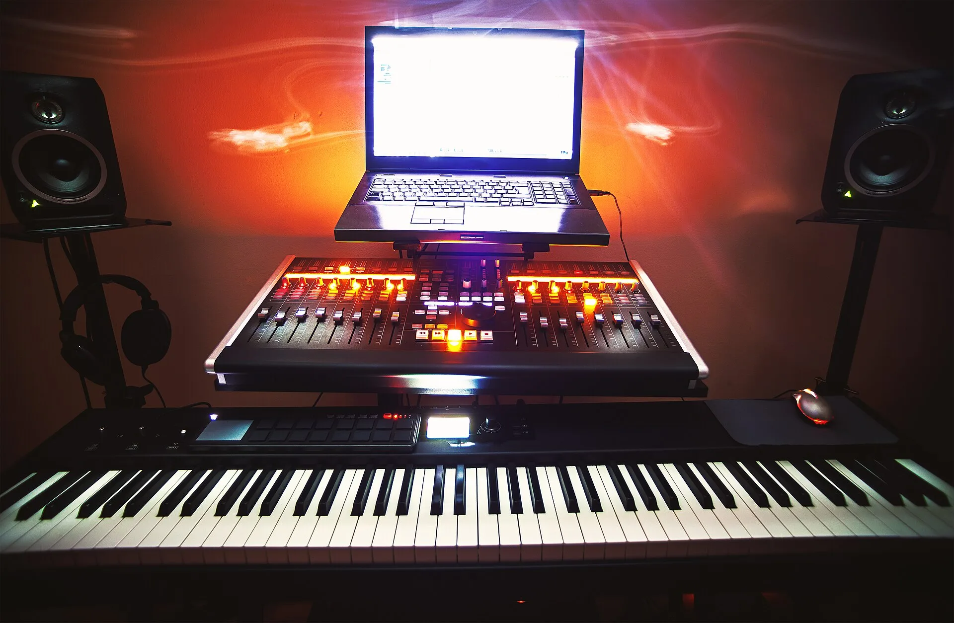 Closeup view on small modern home music studio, keyboard, mixing console and computer. Budgeting SOCAN and Re:Sound licences in a Canadian studio rate card
