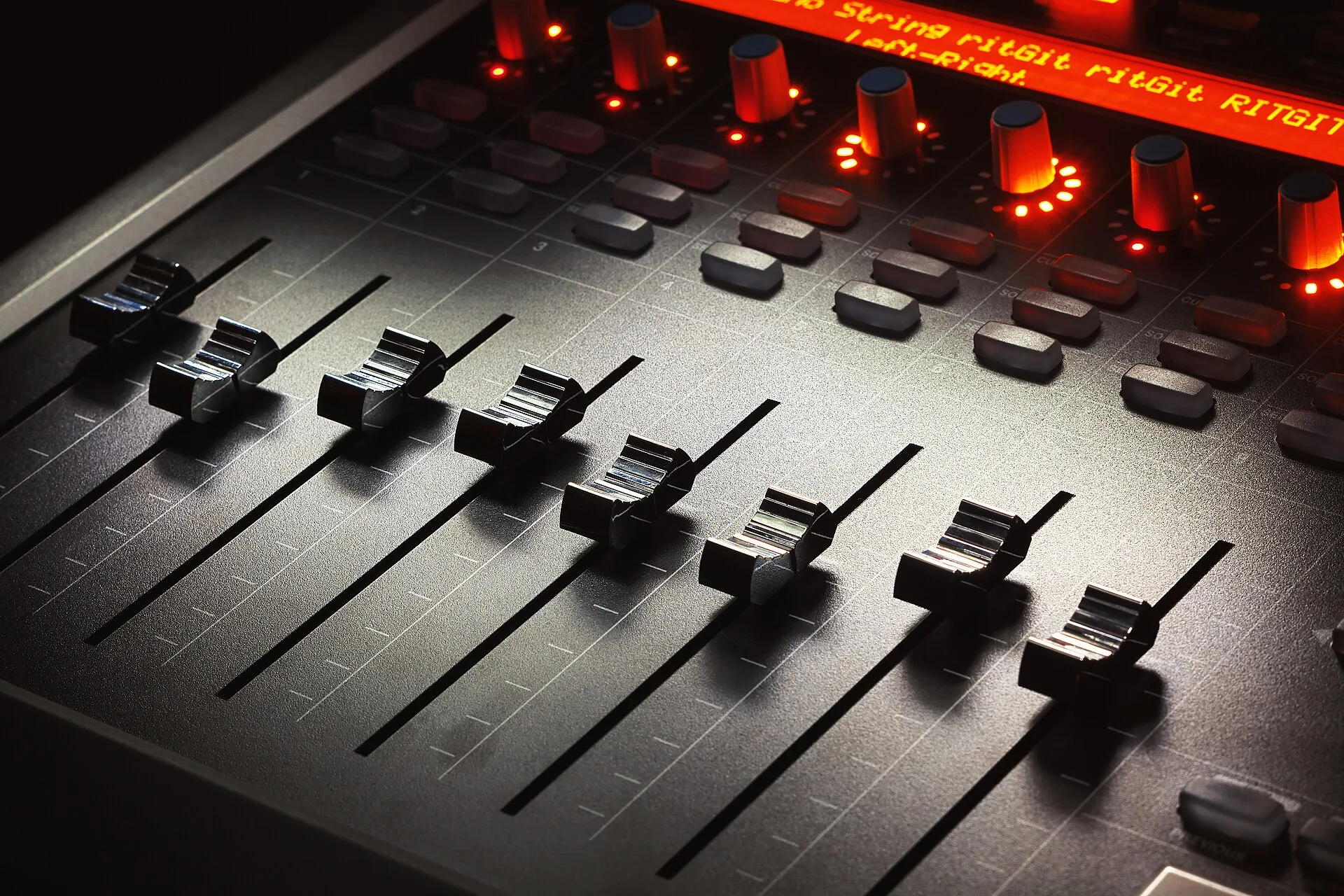 Faders of a modern mixing console, music studio equipment details. SOCAN Re:Sound music studio licence: describe your use